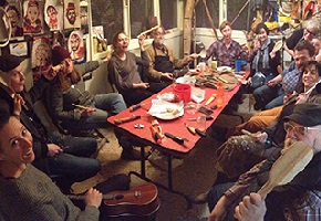 People at a table filled with tools