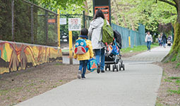 Mother walking to school with her children