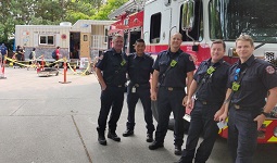 Firefighters standing in front of a firetruck